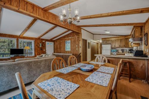a kitchen and dining room with a wooden table and chairs at Mountain View Hideaway -- Pet Friendly, Grill, Wifi, Fire Pit, Deck, Screen Porch, Family Friendly, Game Room, Wood Stove in Morton Grove