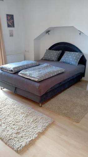 a large bed in a bedroom with a rug at Petra in Livno