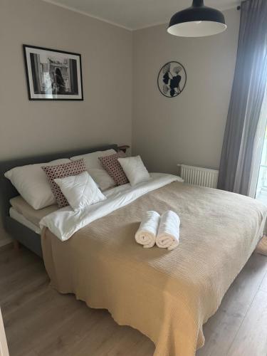 a bedroom with a large bed with towels on it at Apartament 9 Rydzyna in Rydzyna