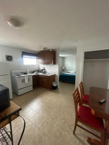 a kitchen and living room with a couch and a table at Thames Inn and Marina in Groton