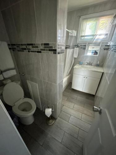 a bathroom with a toilet and a sink at Thames Inn and Marina in Groton