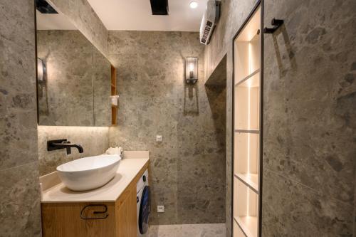a bathroom with a sink and a mirror at Modular Central Studio in Kotor