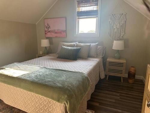 a bedroom with a bed with two lamps and a window at Perfect Lehigh Valley Oasis in Bethlehem