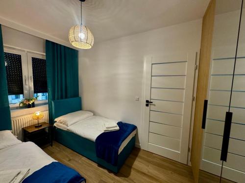 a small room with two beds and a window at LOFT APARTAMENT III NAMYSŁÓw in Namysłów