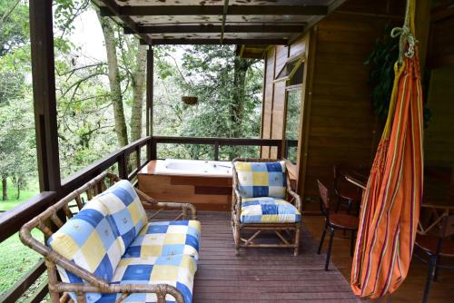 a porch with a hammock and chairs and a tub at Condominio Hacienda Shangrila in San Francisco