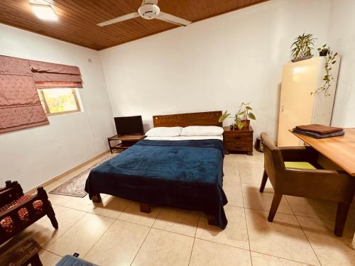 a bedroom with a bed and a table and a desk at House of Sincerity in Maharagama