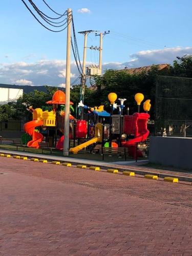a childrens playground with a colorful play equipment at Arriendo Apto Peña Azul La Aldea in Ricaurte