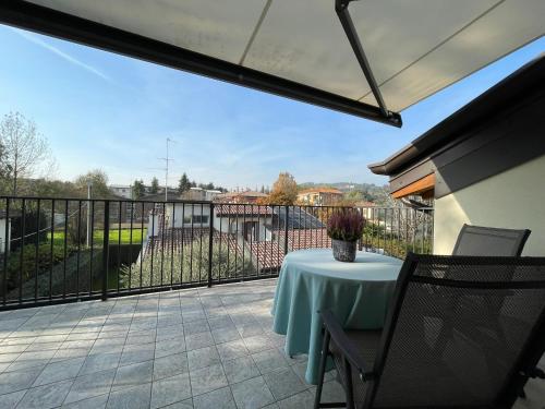 a patio with a table on a balcony at Green Stay Bergamo in Bergamo