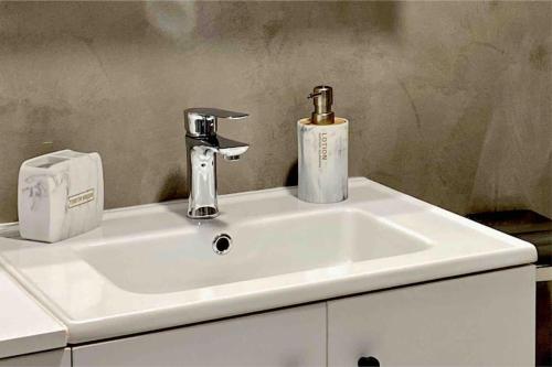 a white sink with a faucet on top of it at The Central Retreat 1 in Mytilini