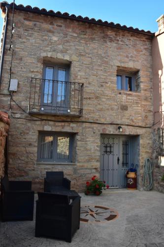 a brick building with a balcony on the side of it at La Casa Rural de Pálmaces in Pálmaces de Jadraque