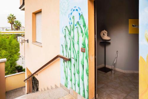 a door with a painting on the side of a building at La Casa Zen in San Giovanni Teatino