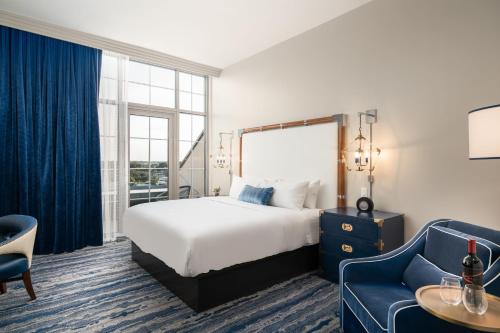 a hotel room with a bed and a couch at JW Marriott Savannah Plant Riverside District in Savannah