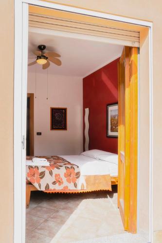 a bedroom with two beds and a red wall at La Casa Zen in San Giovanni Teatino