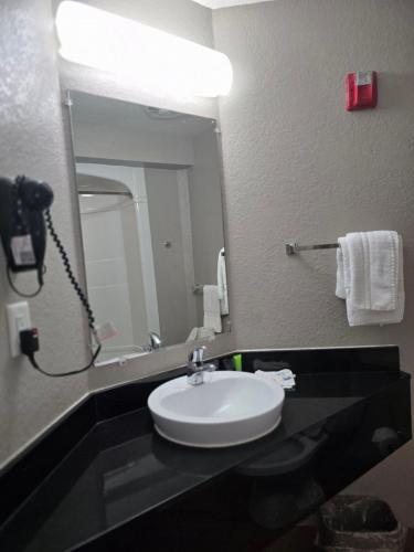 a bathroom with a sink and a mirror at Motel 6-Biloxi, MS - Beach in Biloxi