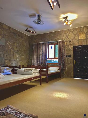a bedroom with two beds and a window at bait bimah travel lodge in Bīmah