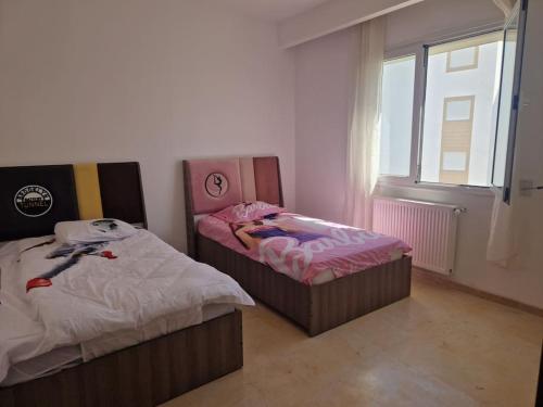 Postel nebo postele na pokoji v ubytování Appartement résidence al amra