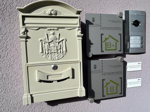 a white box with a crest on it next to two boxes at Suite Romantica Fuga in Roncone