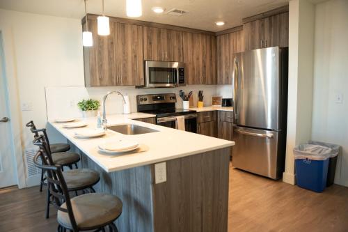 a kitchen with a sink and a refrigerator at Delta Center Downtown Retreat in Salt Lake City
