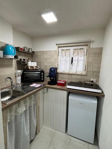 a small kitchen with a sink and a counter top at Suite Cavour Luxury Home Taranto in Taranto