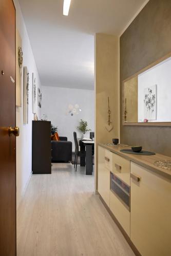 a kitchen and living room with a couch and a table at Angel Home in Quarto dʼAltino