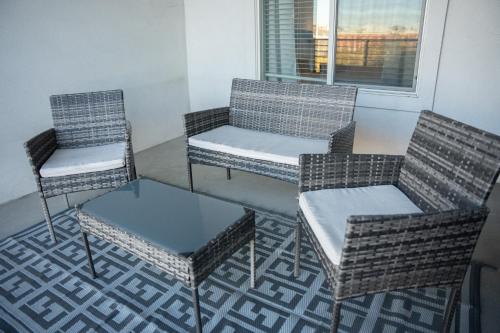 three chairs and a table and two chairs and a window at Delta Center Downtown Retreat in Salt Lake City