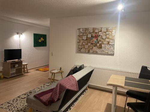 a living room with a couch and a tv at Hofgut Bergchalet Mirabell - Natururlaub am Bodensee in Friedrichshafen