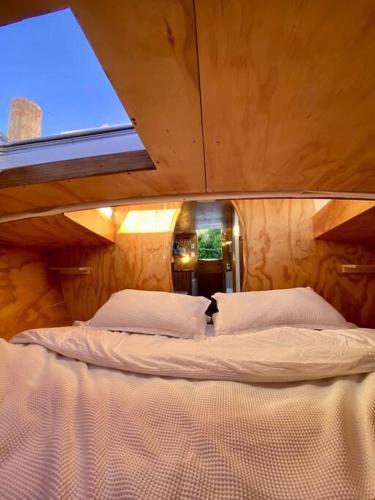 a large bed in a room with a window at Tata Sails - 200m walk to beach in Tata Beach