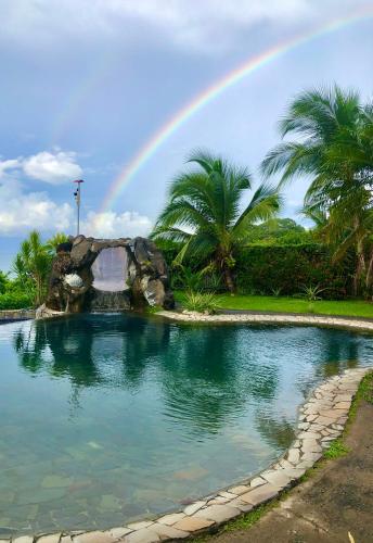 a rainbow over a swimming pool with a rainbow at Casa Vista Pacifico in Esterillos