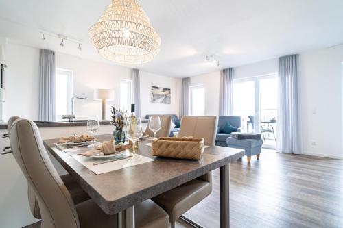 a dining room and living room with a table and chairs at Seaside 49 3 N in Wangerland
