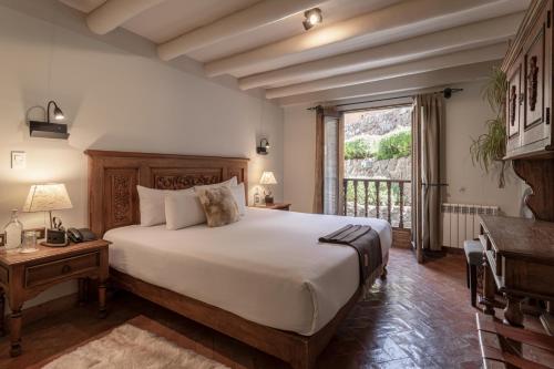 a bedroom with a large bed and a window at Antigua Casona San Blas in Cusco