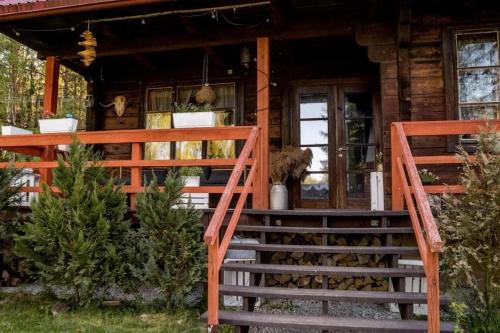 a house with a staircase leading to the front door at In The Woods - Dom z jacuzzi w środku Puszczy Knyszyśnkiej in Supraśl