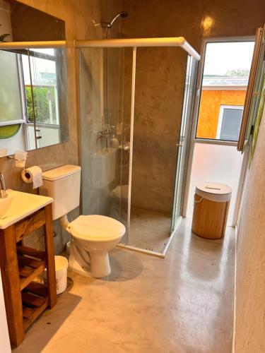 a bathroom with a shower and a toilet and a sink at Ohana rentals in Molinari