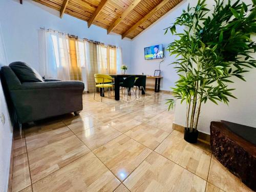 a living room with a couch and a table at Apartamento Brisas de la Montaña in Jarabacoa