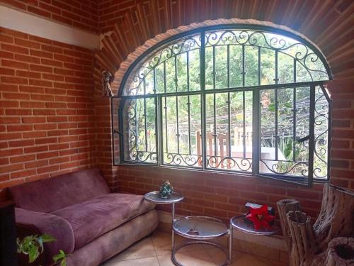 a living room with a couch and a window at Portal Quetzal in Amatlán