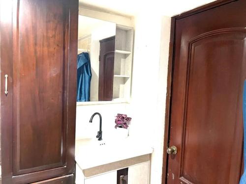 a bathroom with a sink and a mirror at Crea experiencias inolvidables Mini studio in Paraíso