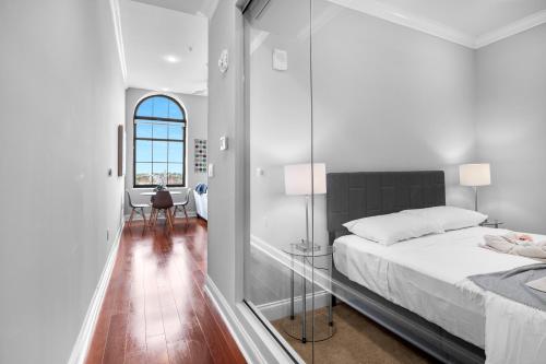 a bedroom with a bed and a glass wall at Stylish 1BR - Rooftop Pool in Philadelphia