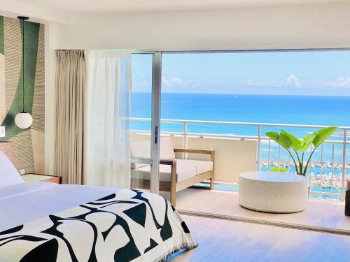 a bedroom with a bed and a view of the ocean at Panoramic Oceanview Resort - Full Kitchen in Each Unit, 2 Swimming Pools, Onsite Restaurants, Fireworks Every Friday in Honolulu