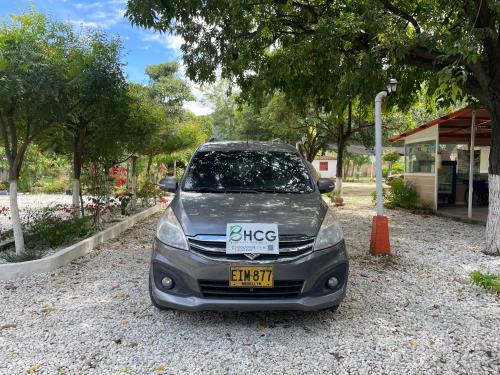 a small car parked in a gravel parking lot at Biohotel Caribe Green in Santa Marta