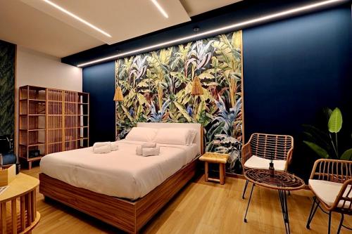 a bedroom with a bed and a painting on the wall at Eterna Suites Roma in Rome