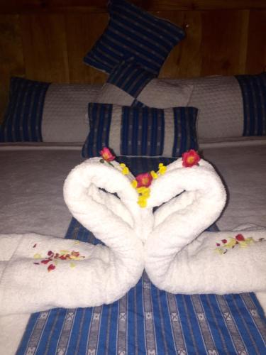 a towel in the shape of a heart on a bed at Sagada Heritage Village in Sagada