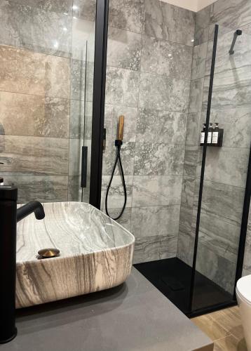 a bathroom with a large tub in a shower at Eterna Suites Roma in Rome