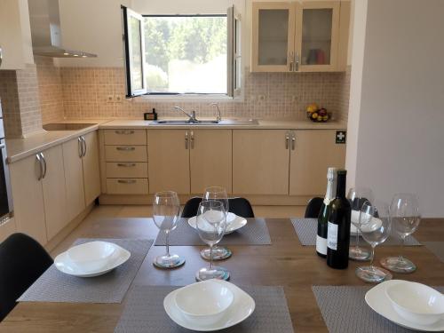 a kitchen with a table with wine glasses on it at Villa Maritsá in Pastida