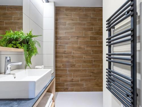 a bathroom with a sink and a mirror at Appartement spacieux avec spa, 4 chambres, parking, Les Saisies - FR-1-810-26 in Les Saisies