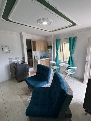 a living room with a blue couch and a kitchen at Apartamento San Gil in San Gil