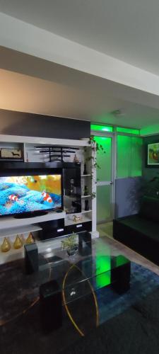 a living room with a large flat screen tv at Sumaq AirPort in Lima