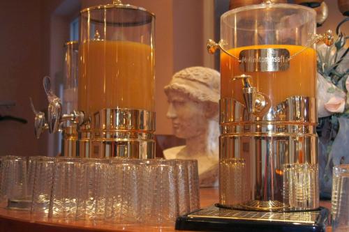 a table with two glass vases and a bust of a woman at KRAL - Residenz Erlangen in Erlangen