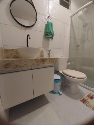 a bathroom with a sink and a toilet and a mirror at Apto Pelourinho Centro Histórico in Salvador