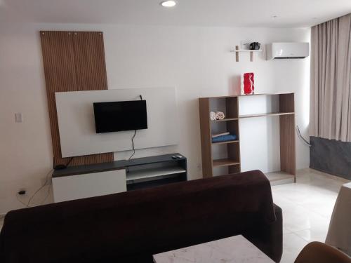 a living room with a couch and a flat screen tv at Apto Pelourinho Centro Histórico in Salvador