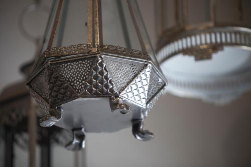 a close up of a light hanging from a ceiling at Jawi Peranakan Mansion in George Town