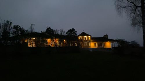 a house lit up at night with lights on at Skönero, Valdemarsvik in Valdemarsvik